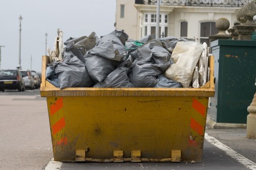 Workers wearing PPE handling waste bins